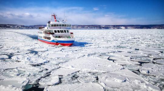 Ice breaker ship navigating through arctic waters
